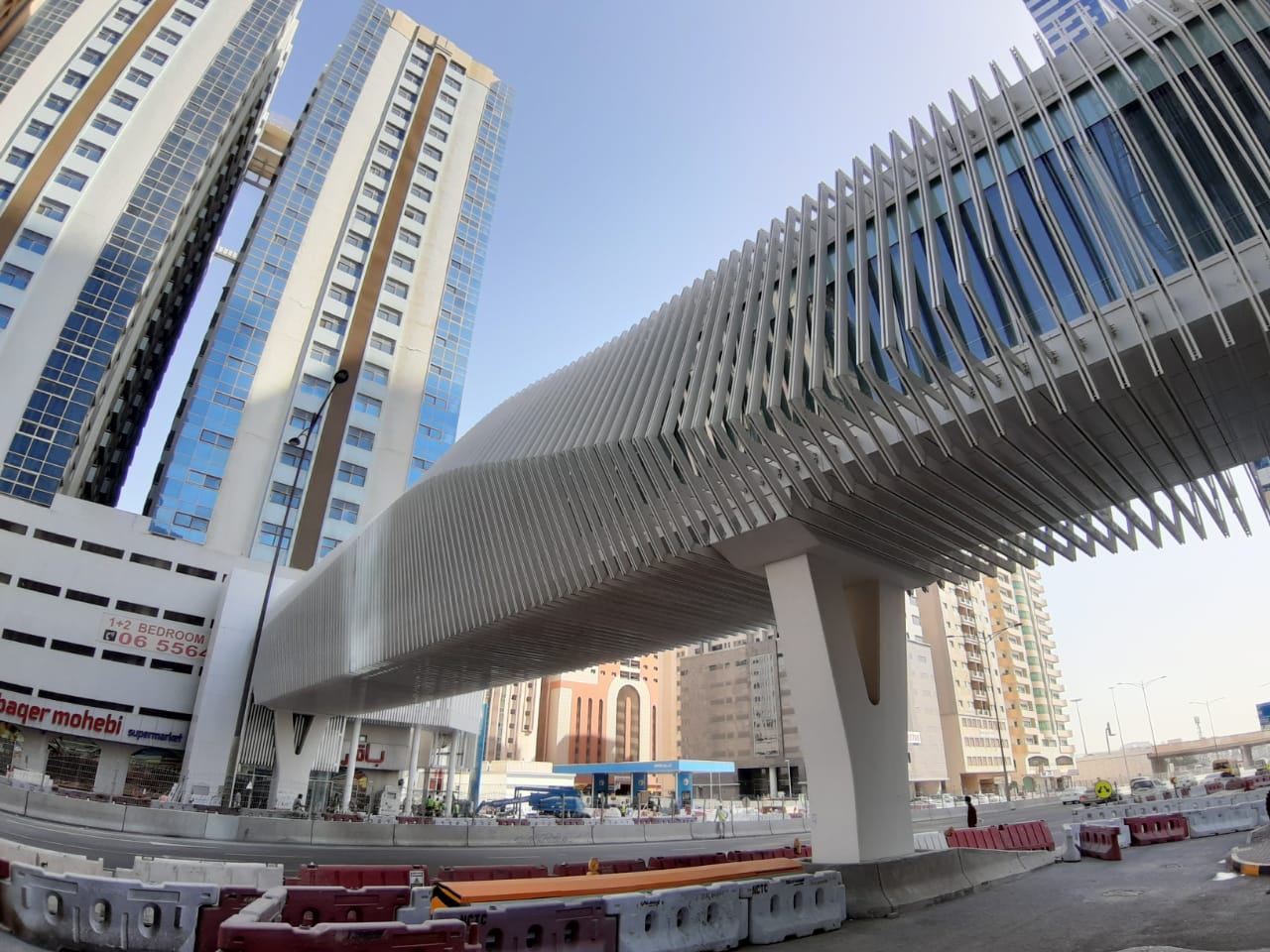 The Al Rayyan pedestrian bridge in Sharjah, wrapped in white aluminium fins