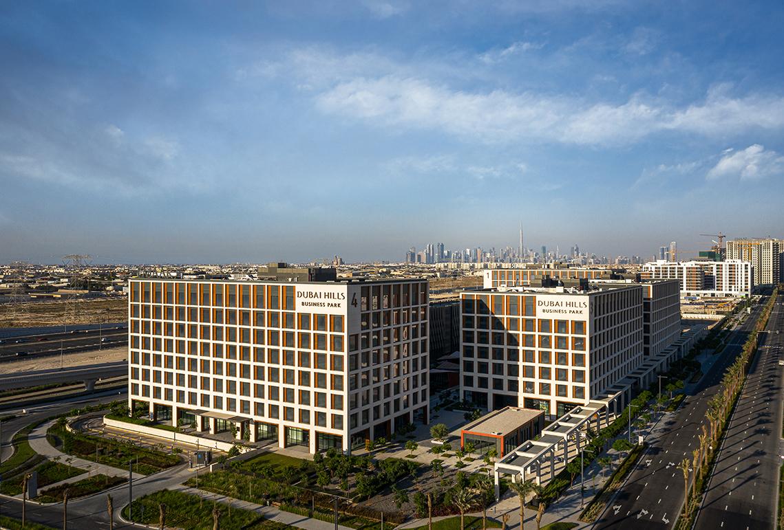 Dubai Hills Business Park from the air, with the Dubai skyline behind
