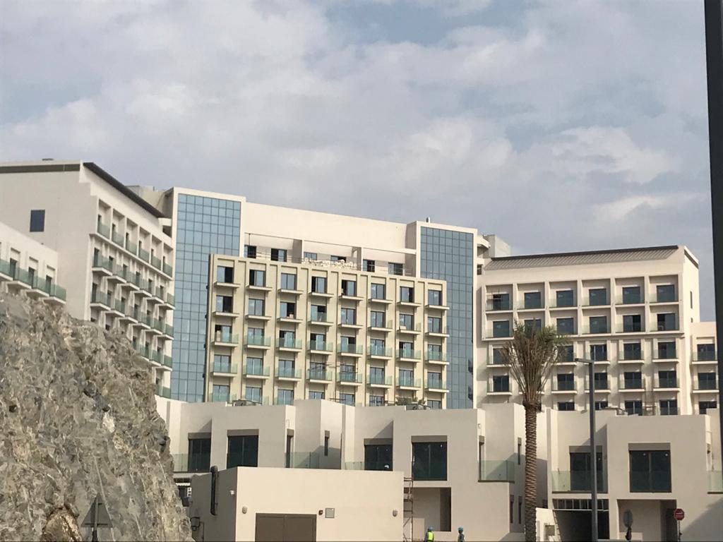 The hotel facade with glass bands