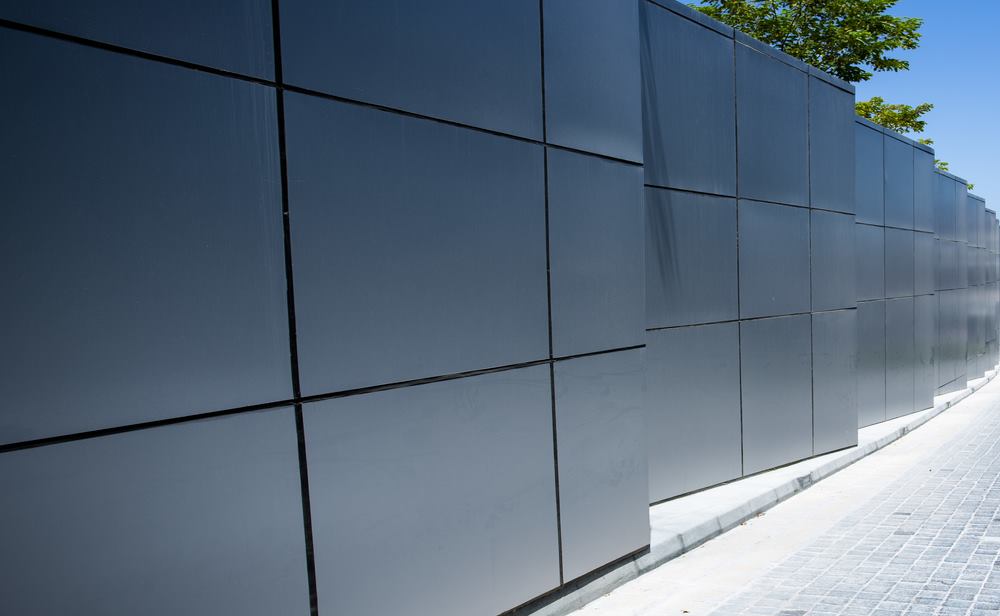 A wall of grey aluminium composite panels