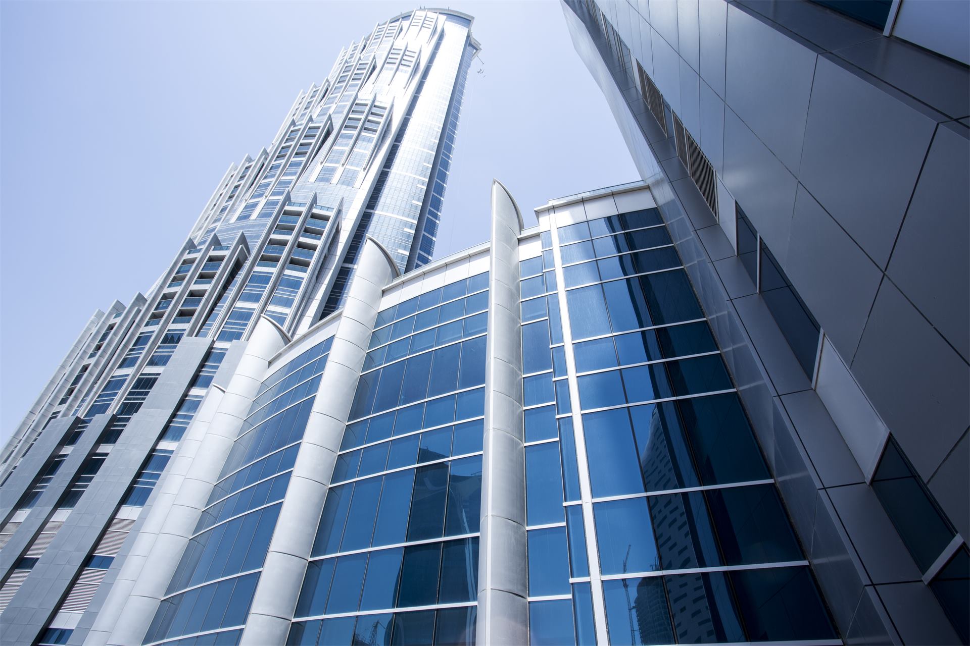 The glass curtain wall of the hotel, seen from below