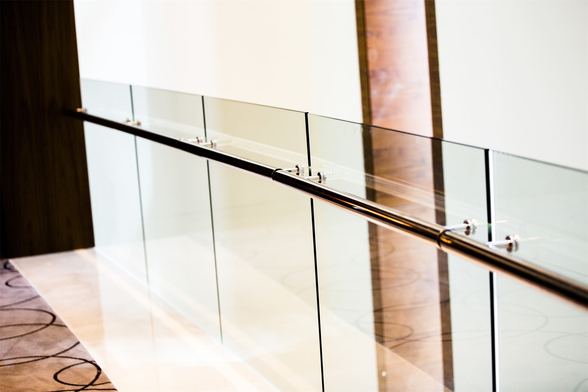 Glass balustrade with a stainless steel handrail