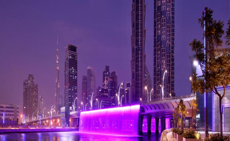 The towers at night, next to the Dubai Water Canal