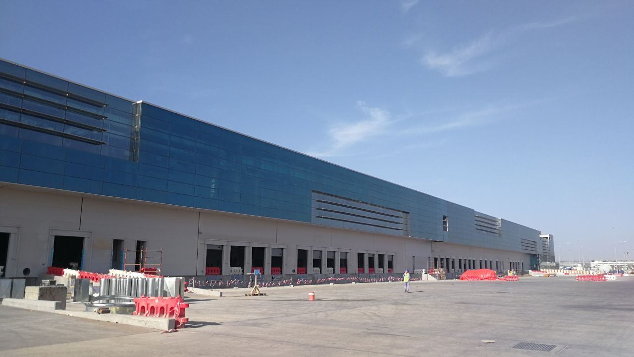 Glass curtain wall along a cargo building