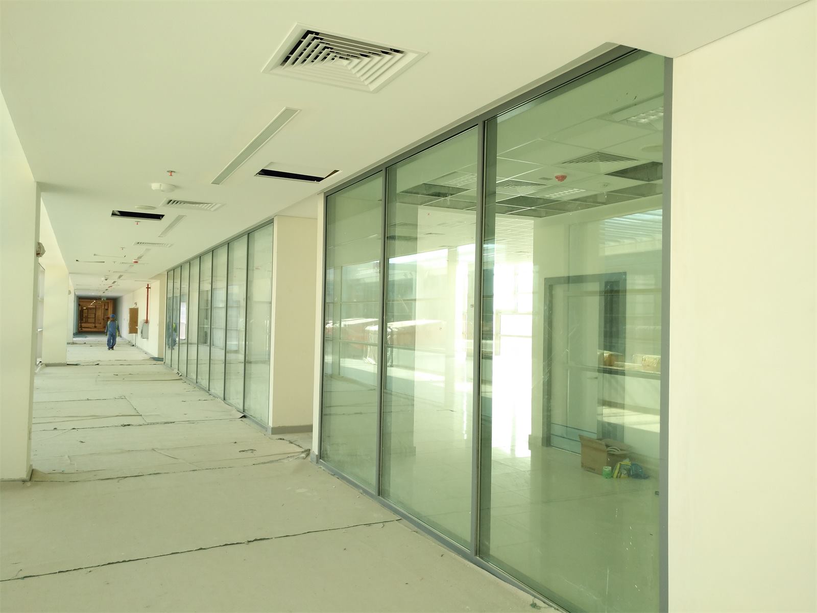 Glass partitions along an office corridor