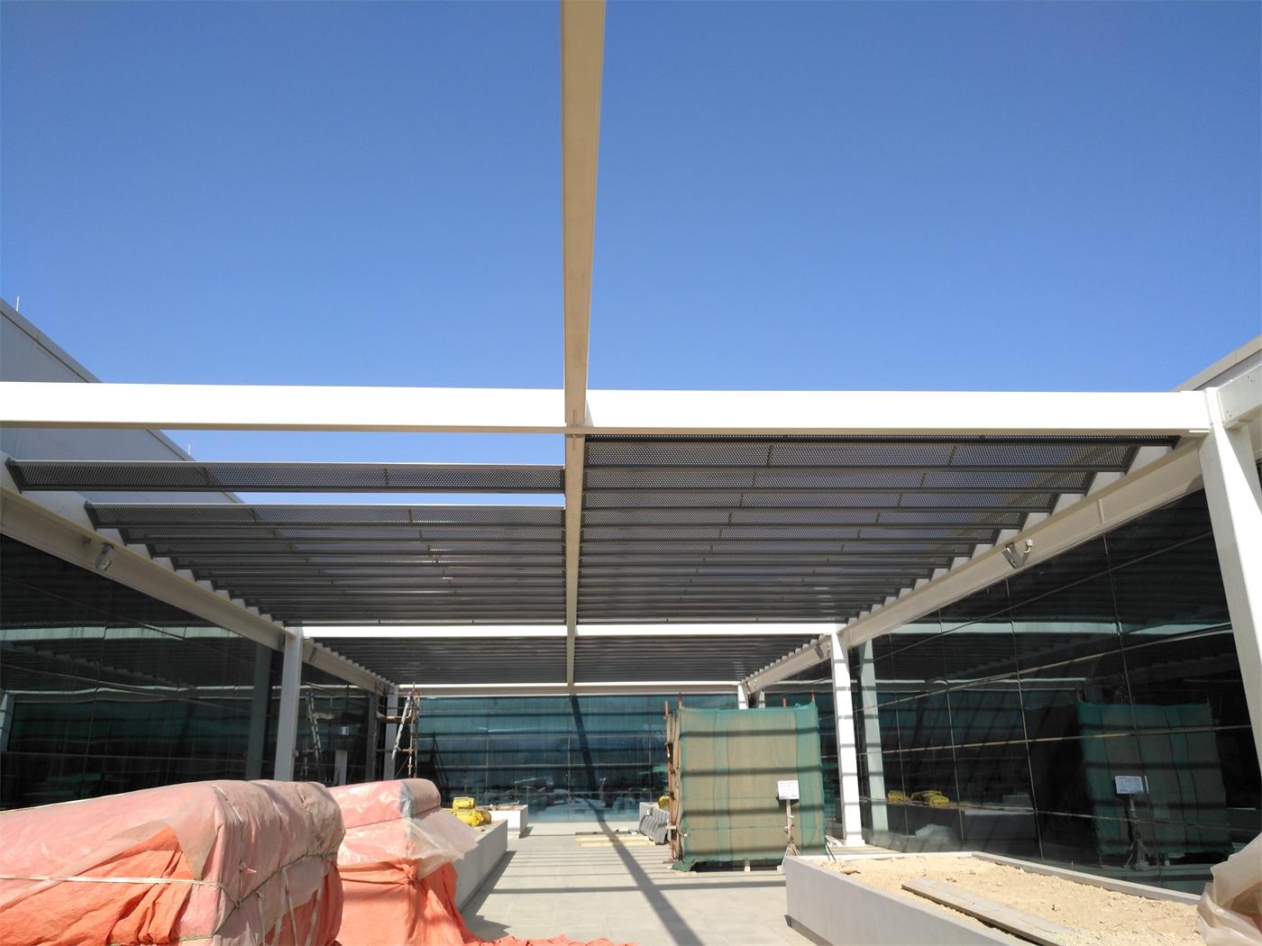 A pergola over a glazed entrance
