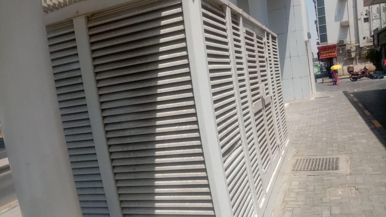 An aluminium louvered enclosure next to a street in Sharjah