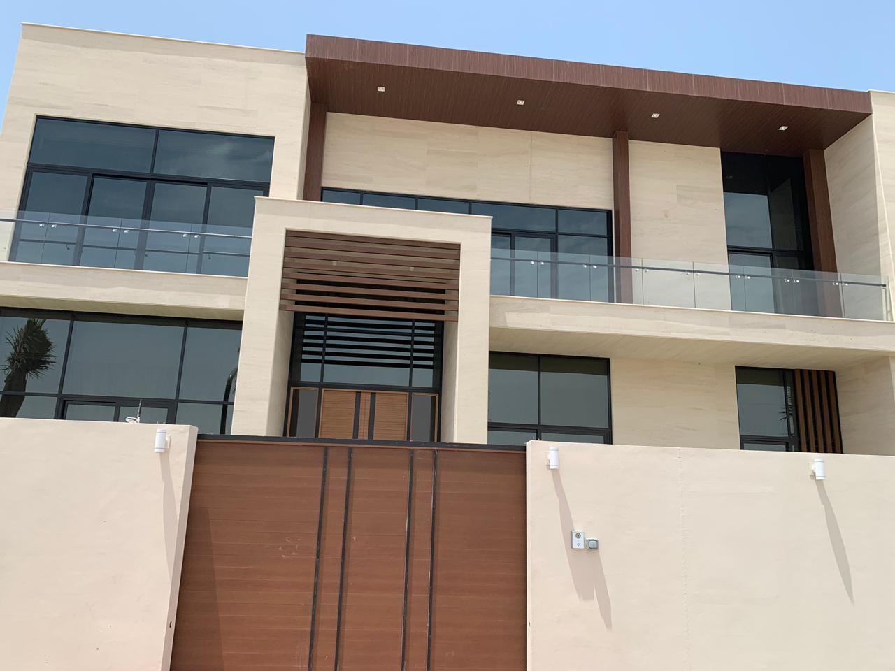 A villa with an ACP frame, glass balconies and a vertical screen